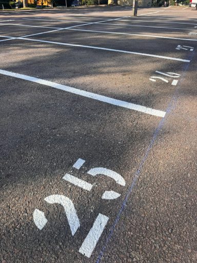 Stadt Freiberg Leere Parkplätze mit weißen Nummern auf asphaltierter Fläche.
